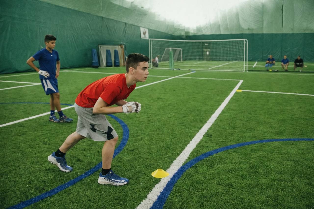 Youth athletes training together on indoor turf
